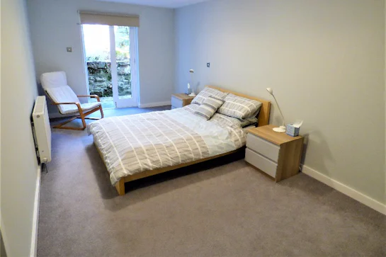 A bedroom with a bed in a room