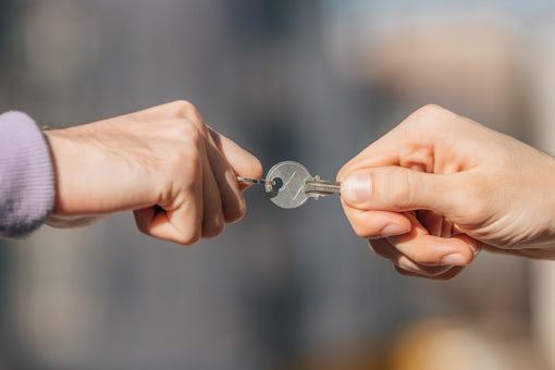 close-up of hands disputing the key to the apartment or rent