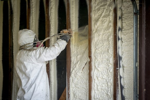man spray foaming walls