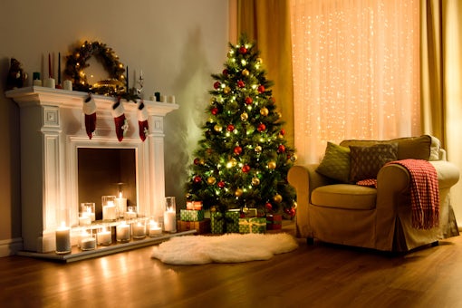 A cozy living room lighted with numerous lights decorated ready to celebrate Christmas