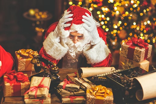 Santa Claus was tired under stress with a headache