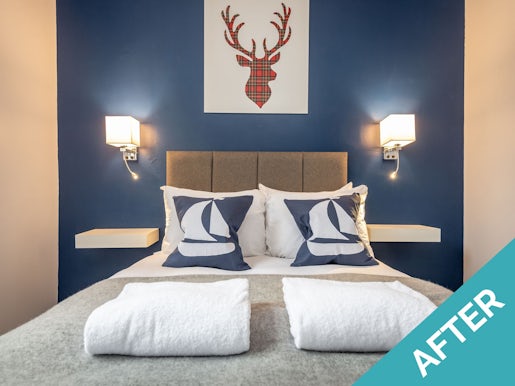 bedroom in st andrews holiday home with blue wall, double bed, and tartan stag portrait holiday home improvements featured image