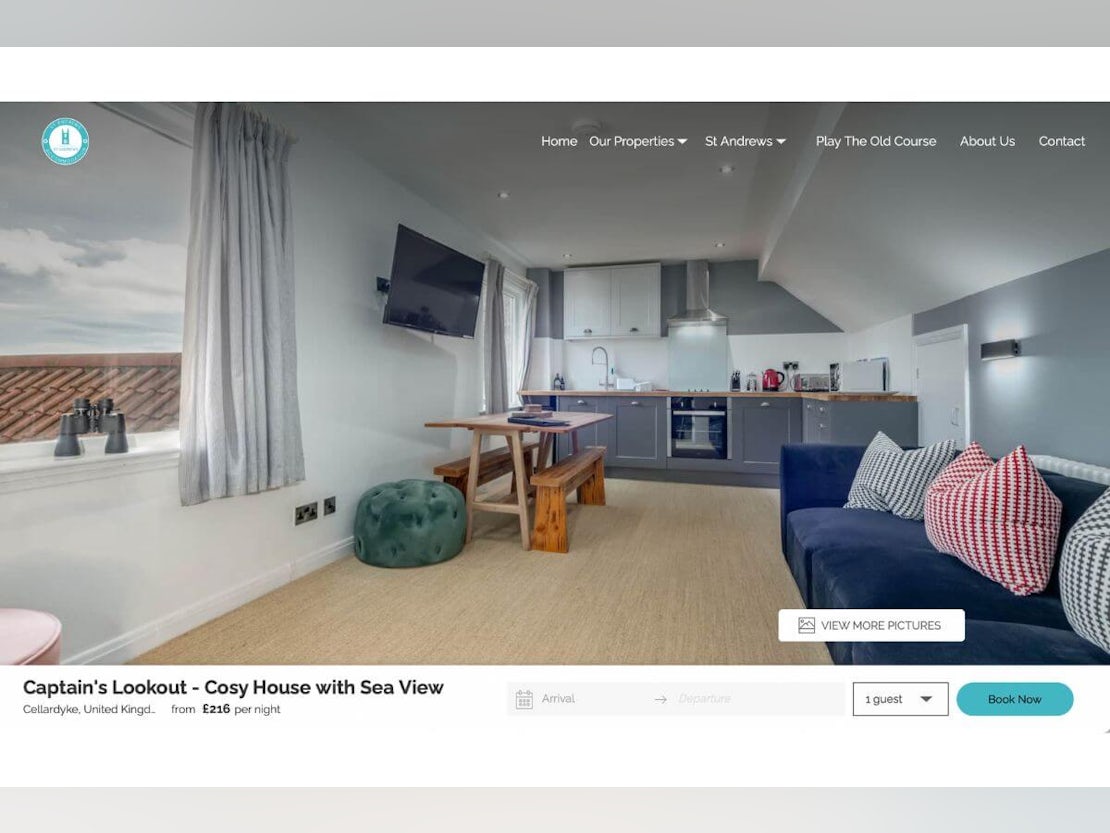 screenshot of a modern open living space with tv, kitchen and sofa