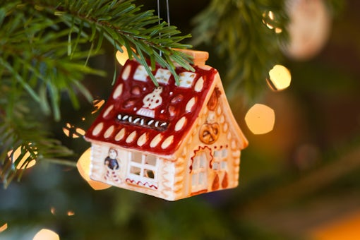 Tiny house toy hanging on a Christmas tree.