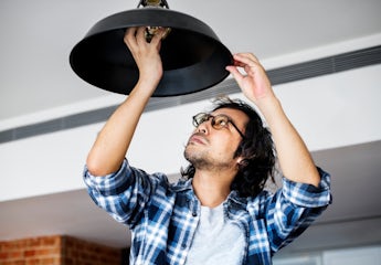Man changing lightbulb at home