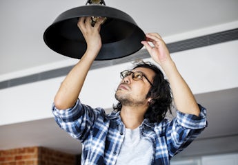 Man changing lightbulb at home