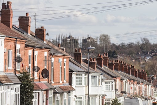 Row of terraced house roofs with chimney stacks