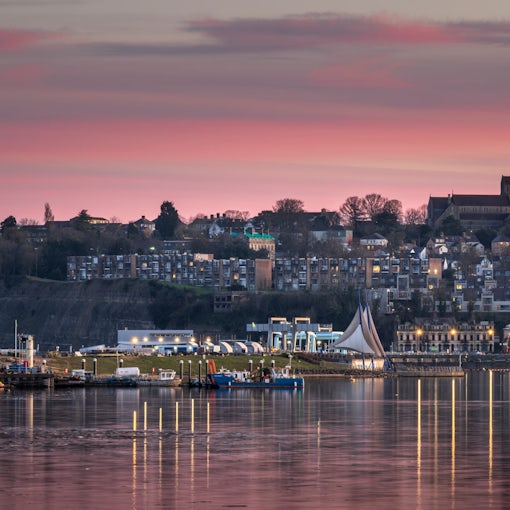 Cardiff Bay, looking towards Penarth, south Wales, during a beautiful, red sunset. The lights are reflecting on the calm water
