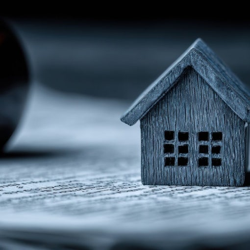 Professional Tenant Rights Law Concept with Miniature House and Judge Gavel on Wooden Desk for Modern Real Estate Legal Advertising Campaigns