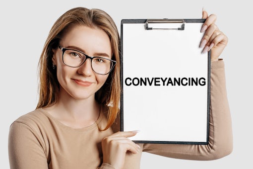 Conveyancing.,Beautiful,Young,Business,Woman,Wearing,Glasses,Holds,A,Clipboard