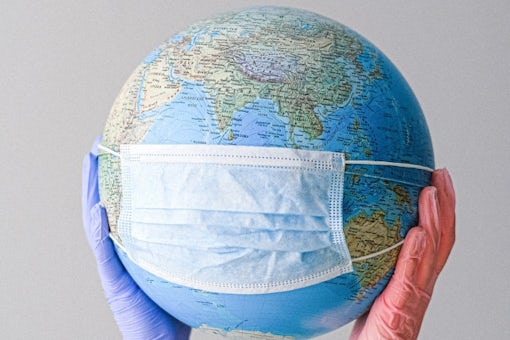 Earth globe with a face mask