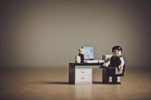Worried lego minifigure in front of a desk