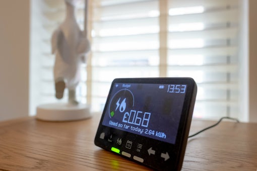 Shallow focus of a dusty digital smart meter showing the amount of used electricity. Seen in the living room of a private house.