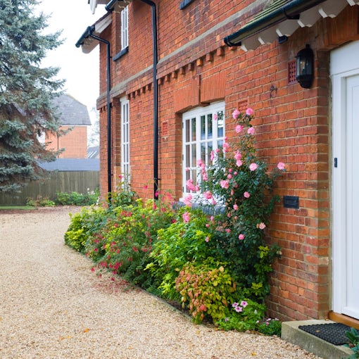 A well-presented red-brick house with a white door, neat gravel driveway, and blooming garden — representing the type of property tenants look for in Sleaford this autumn.