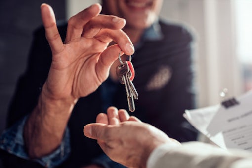 real-estate-agent-passing-keys-his-client_137573-830