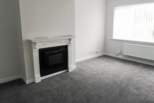 Newly renovated living room with new fireplace and carpets ready