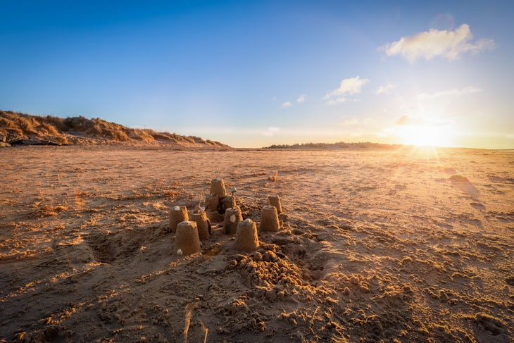Sand castle on gorgeous Norfolk beach at sunset