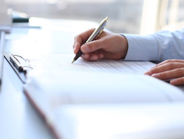 Businesswoman hands pointing at business document