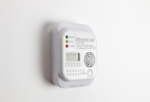 Carbon monoxide detector on a white wall. Stay home safe. Home control and security.  CO detector