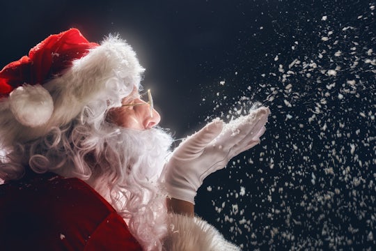 Santa blowing snow.