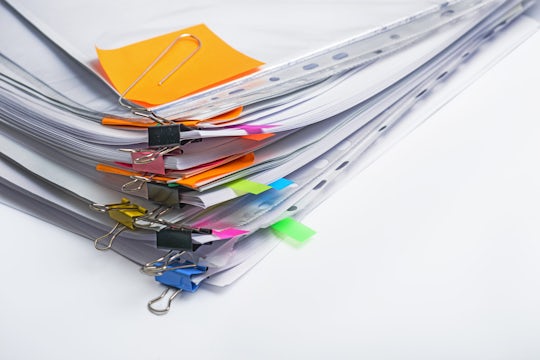 Pile of legal documents with sticky notes.