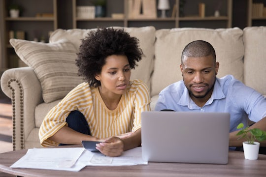 Woman and man on a laptop, sending application for rental property.