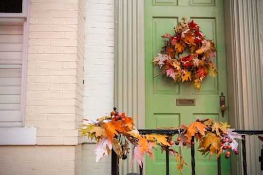House for sale's front door with autumn decoration.
