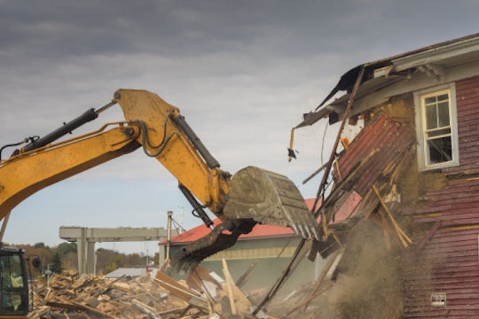 Excavating machine demolish a building