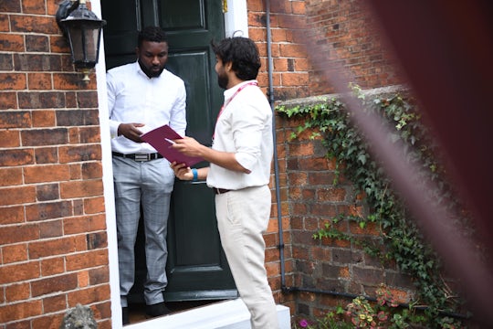 Tenant and letting agent having a conversation at the front door.