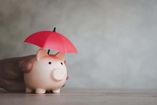 Piggy bank with red umbrella