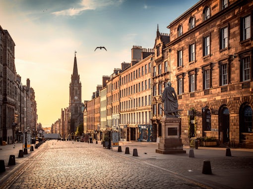 The view of the Royal Mile and the Adam Smith Statue in the sunrise hours