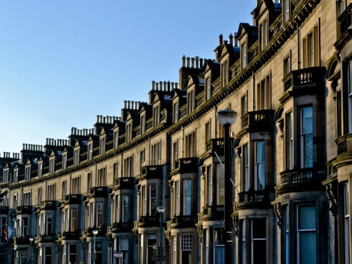 Georgian crescent in Edinburgh, Scotland, showing a row of historic buildings with classic architectural details.